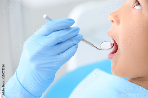 Fototapeta Naklejka Na Ścianę i Meble -  Dentist examining little boy's teeth in clinic, closeup