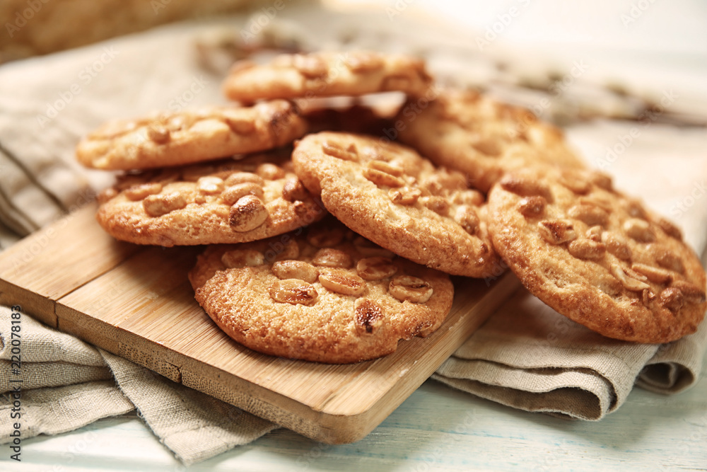 Board with delicious cookies on table, closeup