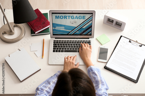 Woman using laptop to pay m...