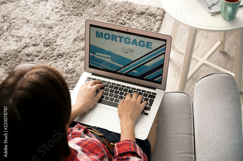 Woman using laptop to pay m...