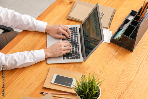Man using laptop to pay mor...