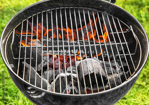 Barbecue grill with burning firewood, closeup