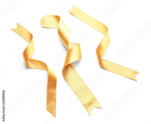 Curled golden ribbons on white background