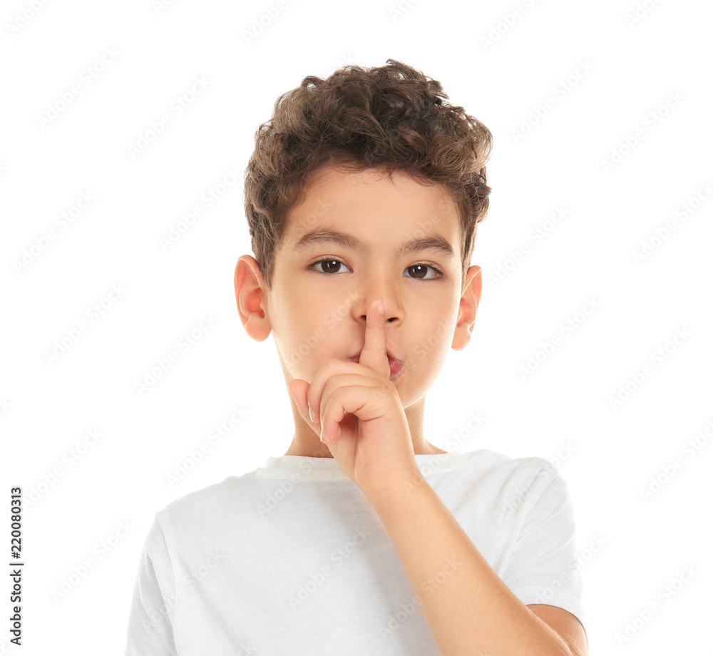 Cute little boy showing silence gesture on white background Cute little boy showing silence gesture on white background