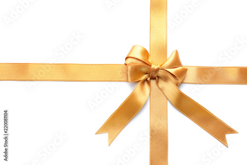 Golden satin ribbons with bow on white background