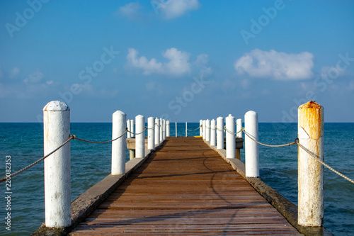 Wood pier on beach with beautiful sky © badyur