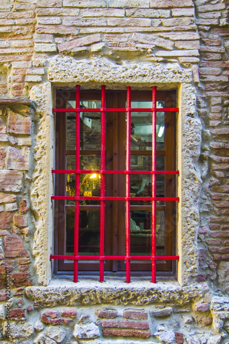 window with red grating and light inside