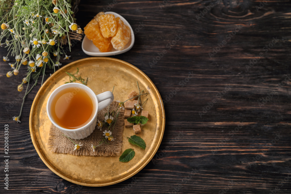 Cup of delicious camomile tea and honeycombs on wooden table Cup of delicious camomile tea and honeycombs on wooden table
