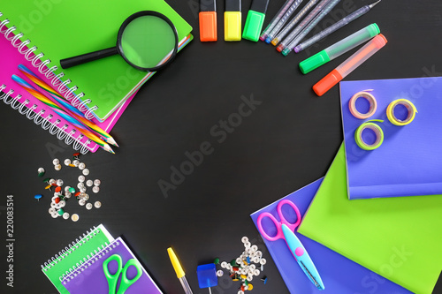 Frame made from school stationery on dark background