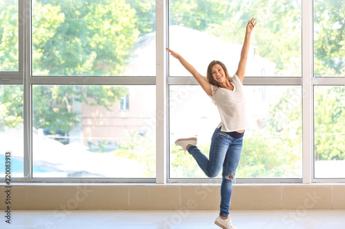 Free Download Happy young woman with key from her new house indoors - GFXLoad