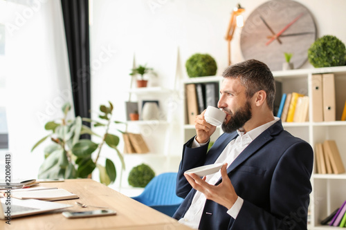 Businessman drinking coffee...
