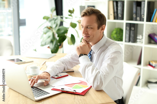 Businessman working with la...