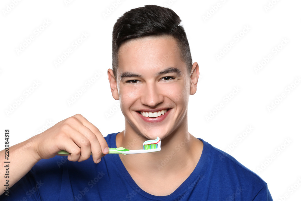 Young man brushing teeth on white background Young man brushing teeth on white background