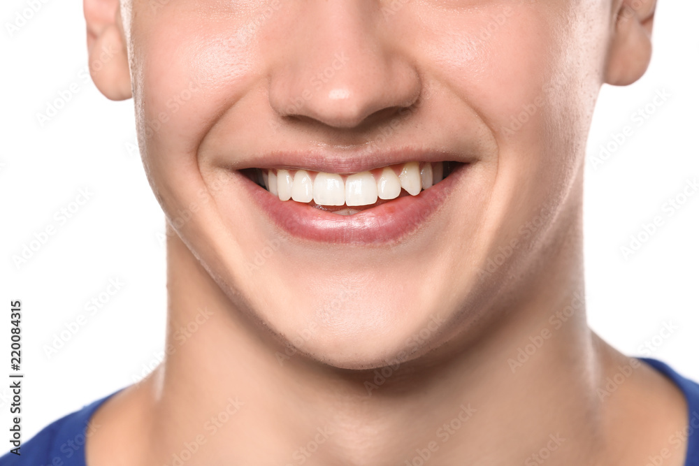 Young man with healthy teeth smiling on white background, closeup Young man with healthy teeth smiling on white background, closeup