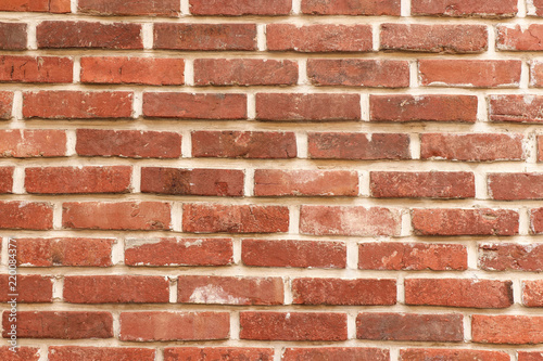 the textured wall of brown brick