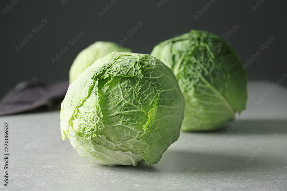 Fototapeta premium Fresh whole cabbage on grey table