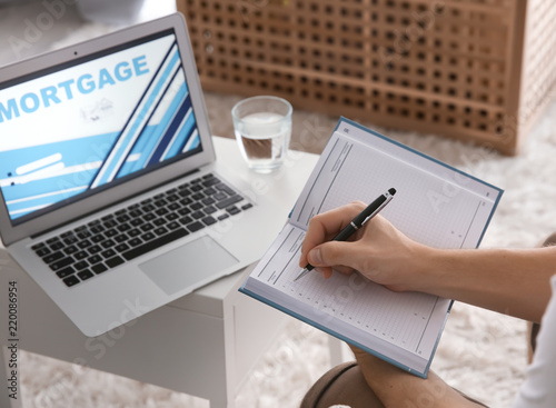 Man writing in notebook nea...