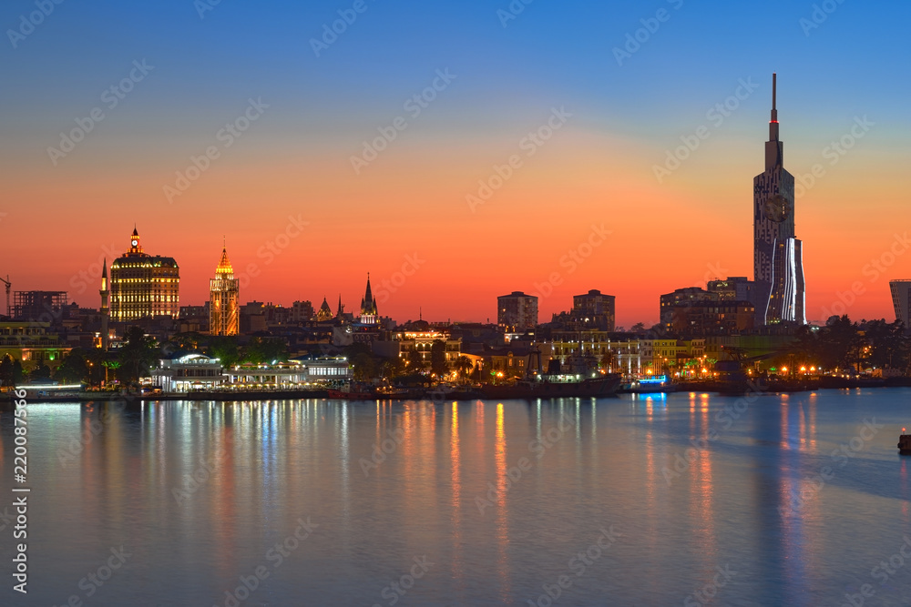 Batumi, Georgian resort city and port at Black Sea – view of city centre from sea in red summer sunset light