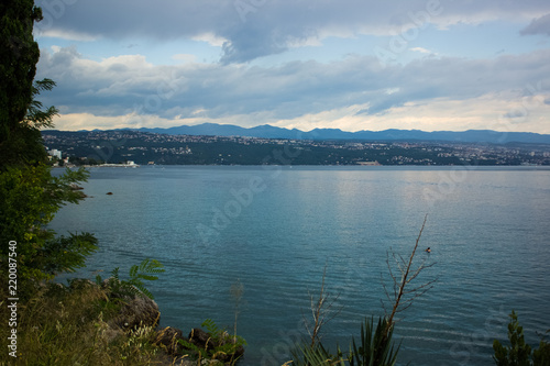 sea waterfront shore line of small resort city in tropic district in summer rainy weather time before storm