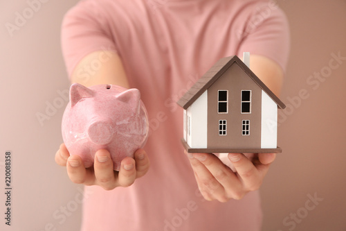 Man holding house model and...