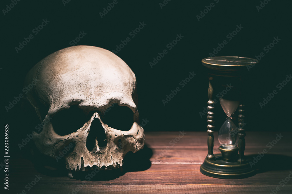 Skull and vintage hourglass on wooden background. Drama or horror concept.  Stock Photo | Adobe Stock