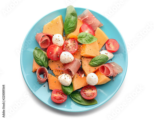 Delicious salad with melon and prosciutto on white background