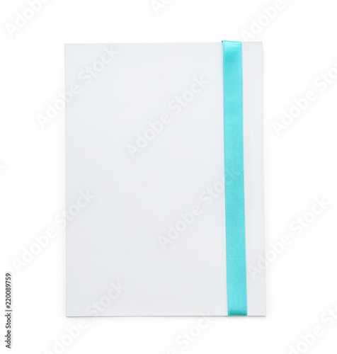 Blank paper card with turquoise ribbon on white background