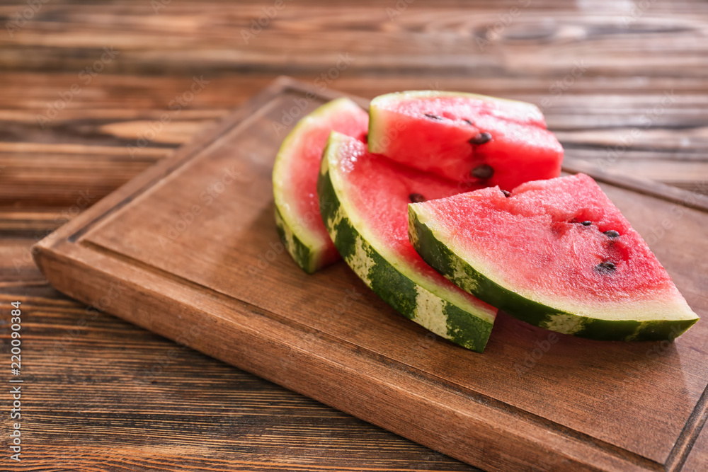 Slices of ripe watermelon on wooden board