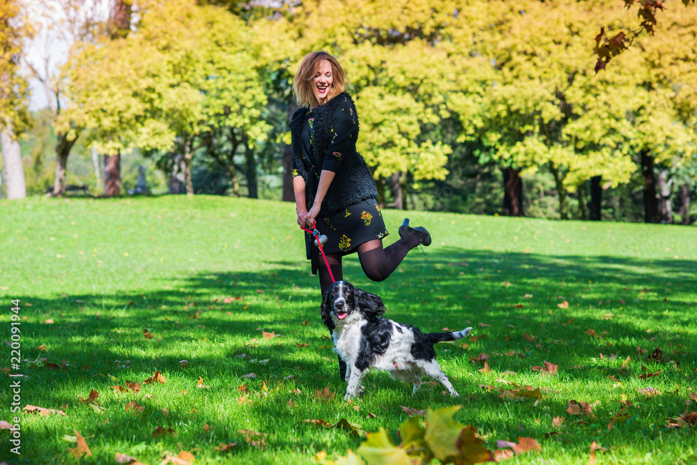 cheerful girl playing with a dog in the park cheerful girl playing with a dog in the park