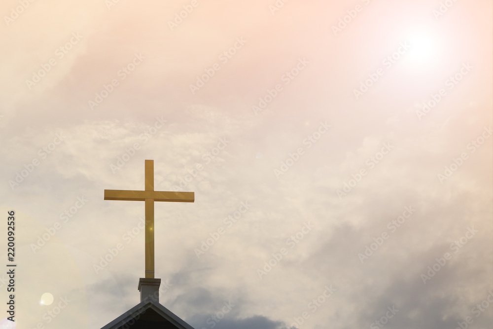 Golden holy cross on chapel roof with spiritual sky background, symbol for Jesus Christ, resurrection and salvation.