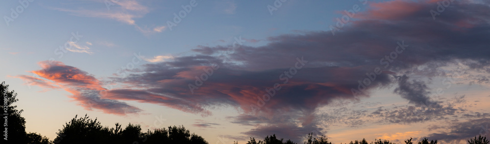 A large cloud tinged red at sunset A large cloud tinged red at sunset