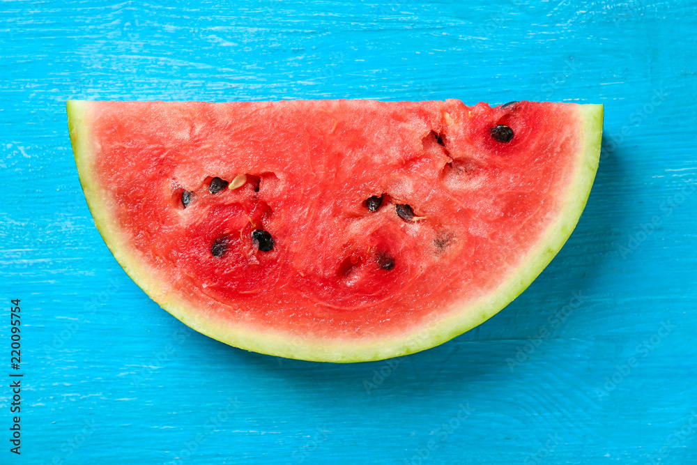Slice of fresh watermelon on color table Slice of fresh watermelon on color table