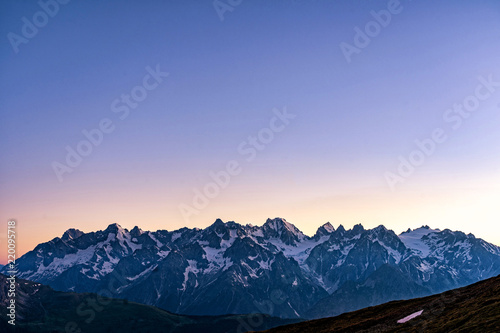 Scenic view of beautiful Swiss Alps mountains. Blue hour sunset with pink and blue tones, Verbier, Canton du Valais, Wallis, Switzerland. © 1tomm