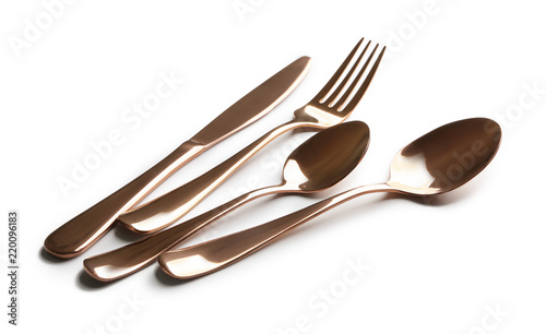 Spoons, fork and knife on white background