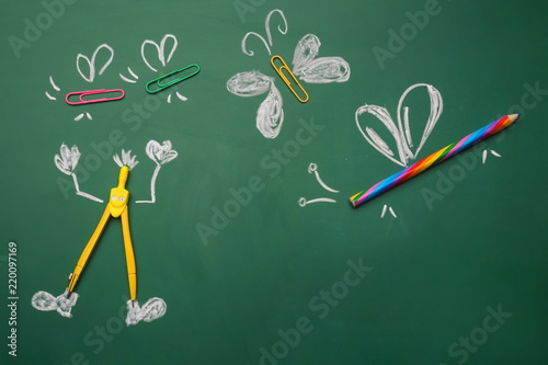 Creative composition with school stationery on chalkboard