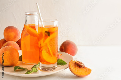 Peach cocktail in glassware on white table