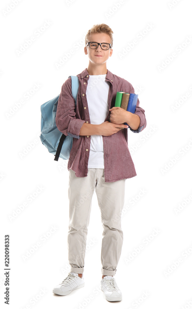 Teenage boy with backpack and books on white background