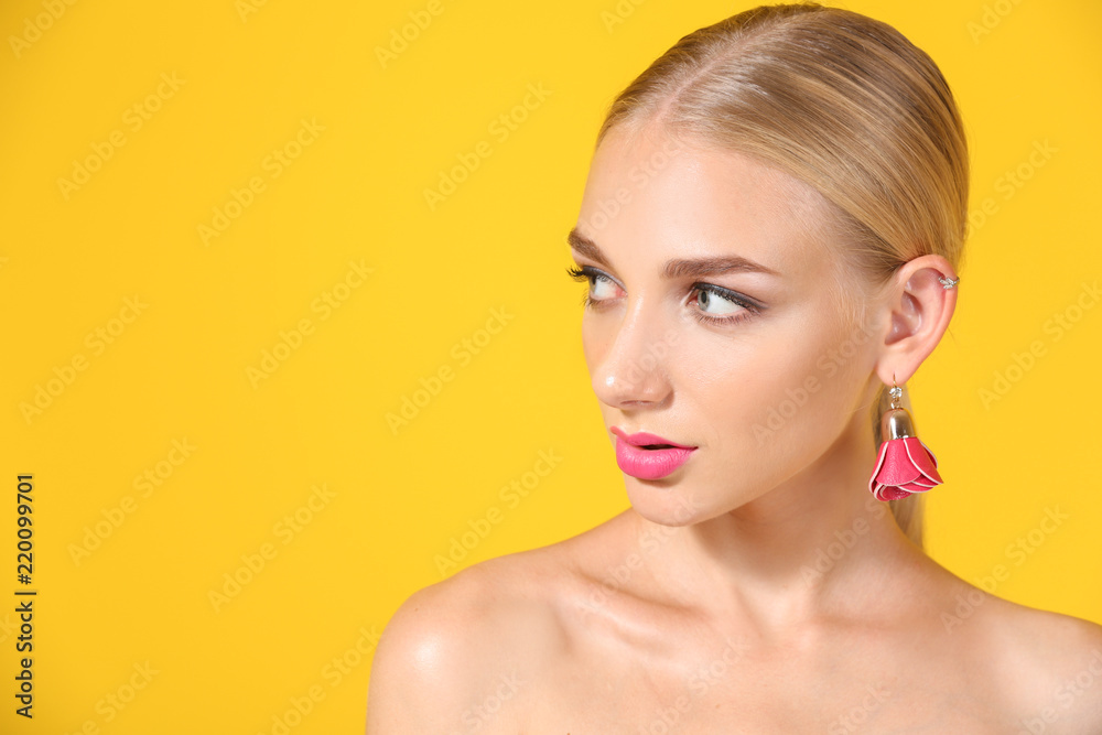 Beautiful young woman with bright pink lipstick on color background