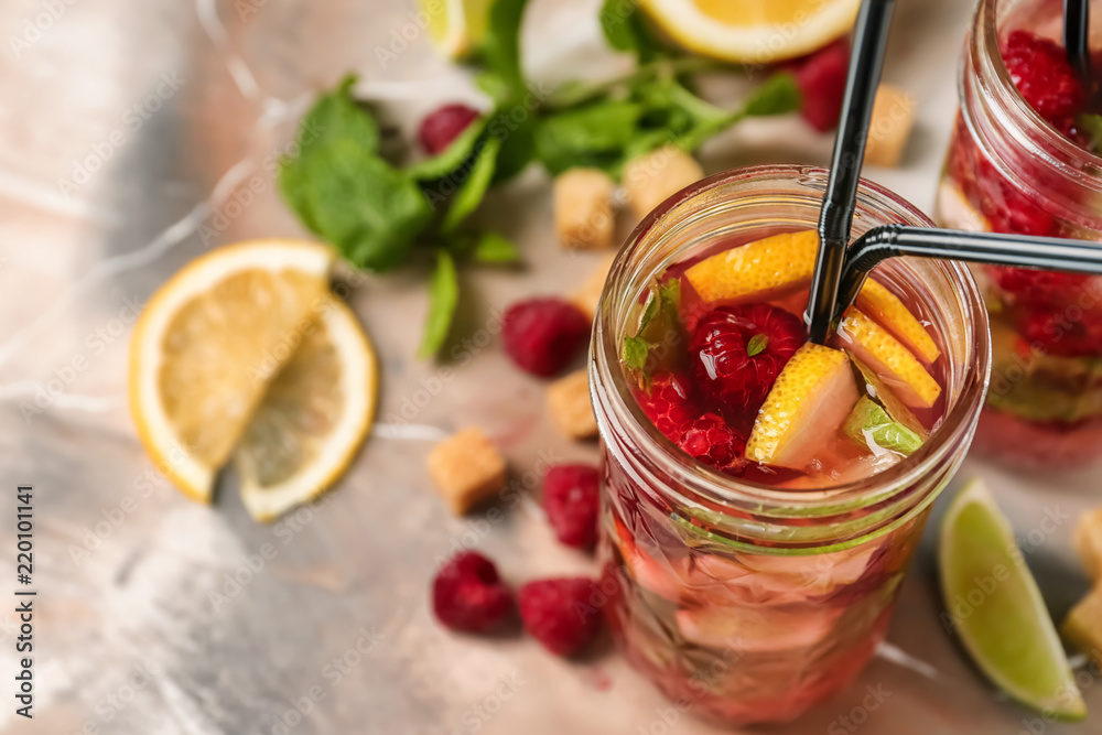 Jar of fresh raspberry mojito on table Jar of fresh raspberry mojito on table