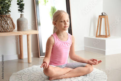 Little girl practicing yoga...
