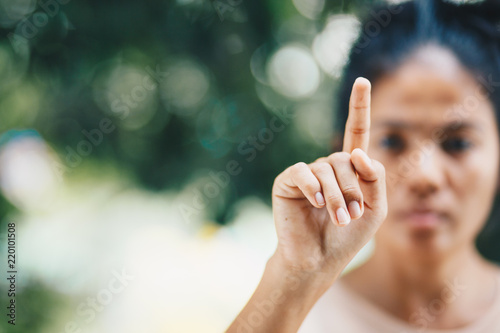 Woman's hand pointing on object with forefinger , copy space