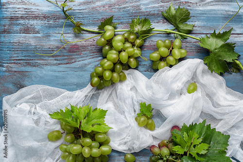 Fresh green grapes with lea...
