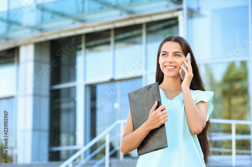 Young businesswoman talking...