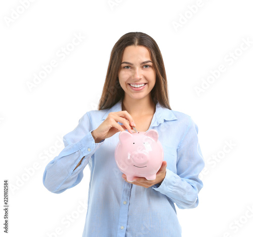 Young woman putting money i...