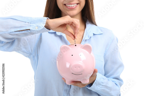 Young woman putting money i...