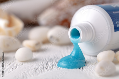 toothpaste with sea shells and toothbrush on a white background