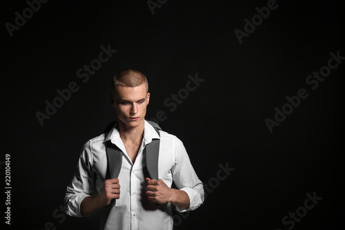 Sad teenage boy on dark bac...