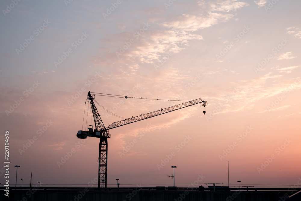 Construction crane at sunrise Construction crane at sunrise