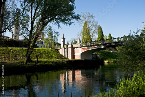 Tableau sur toile The Adam and Eve bridge over the Noncello river in Pordenone