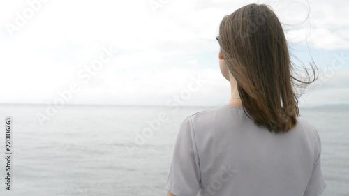 Young woman is looking into the distance.